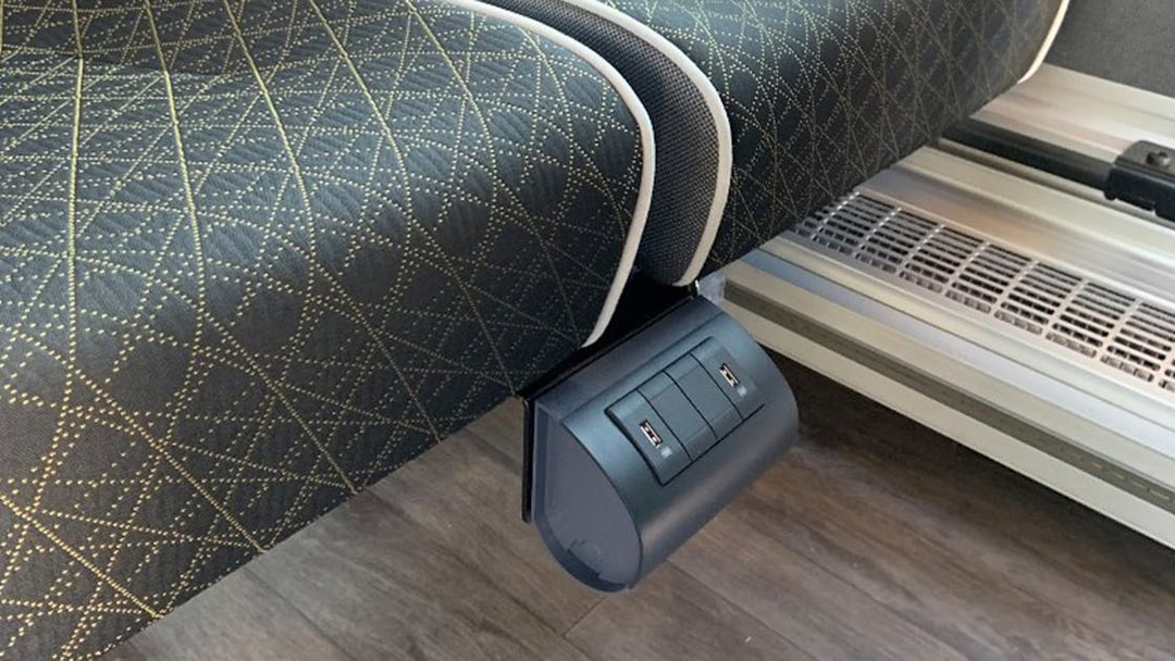USB charging ports under a seat on the SIT shuttle bus from Fiumicino Airport to Rome city center.