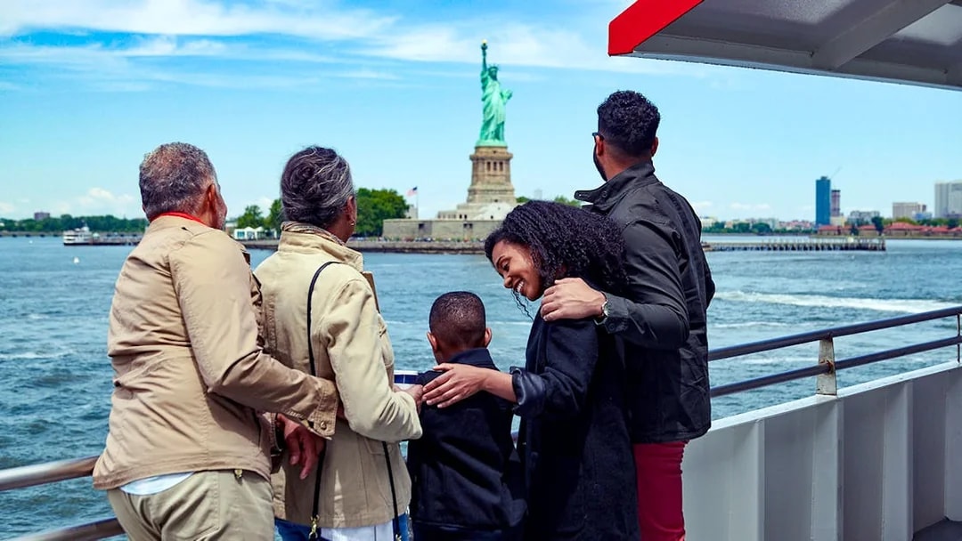 Family on a boat tour viewing the Statue of Liberty in New York City.