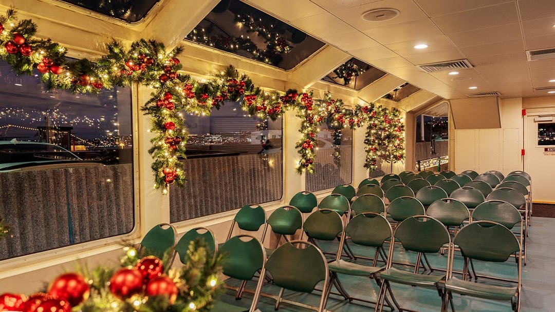 Interior of a festively decorated boat with garlands and lights, Circle Line Harbor Lights Cruise.