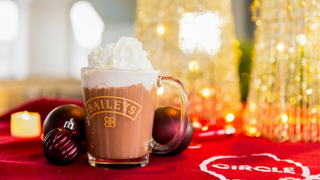 Baileys hot chocolate with whipped cream on a festive table during Circle Line: Harbor Lights Cruise.