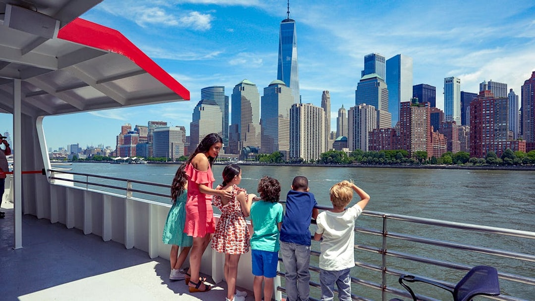 Cruise passengers view New York City skyline, including One World Trade Center, on Circle Line Liberty Midtown Cruise.