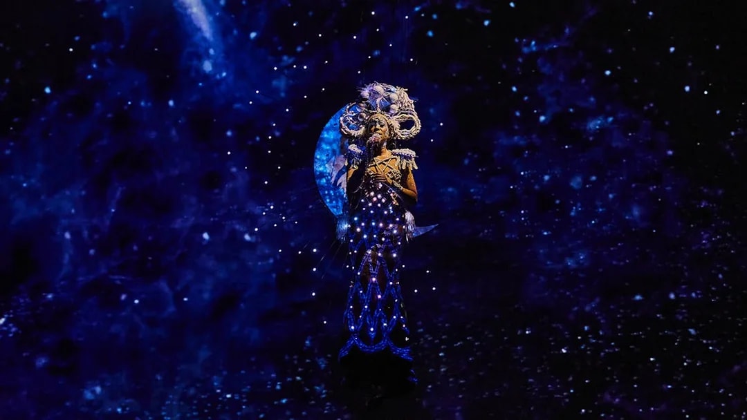 Performer in illuminated costume during Michael Jackson ONE show.