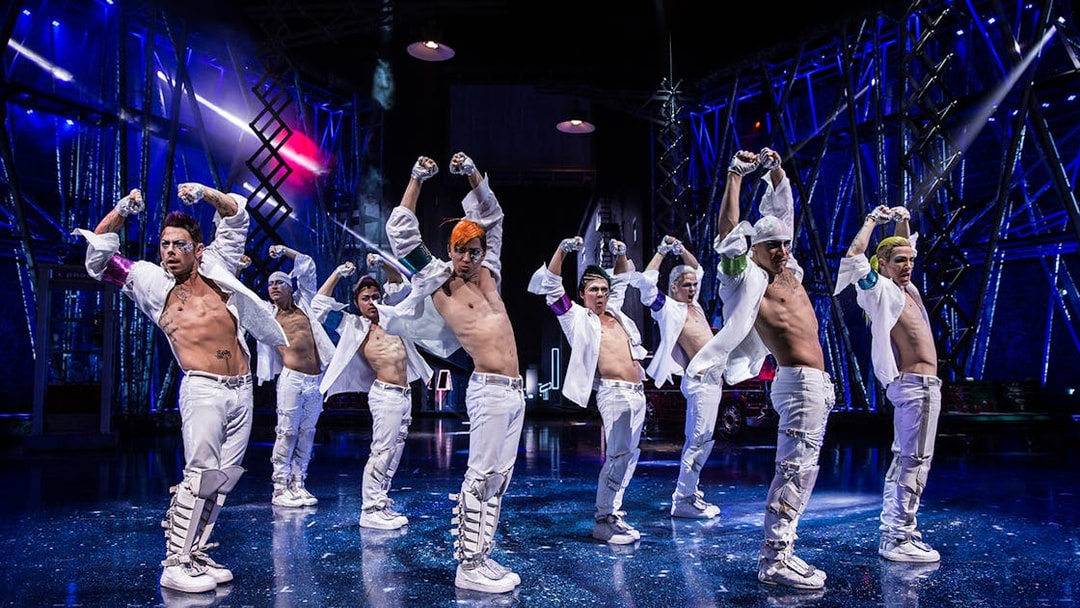Performers in white costumes dancing at Michael Jackson ONE show.