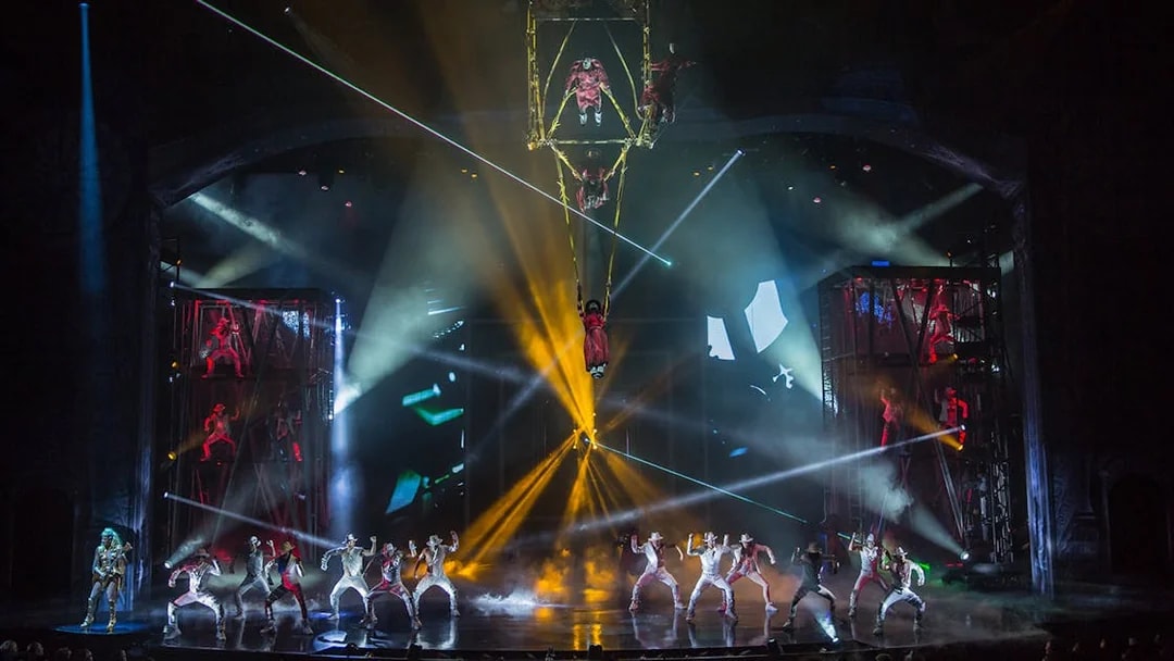 Performers on stage with vibrant lights at Michael Jackson ONE show.