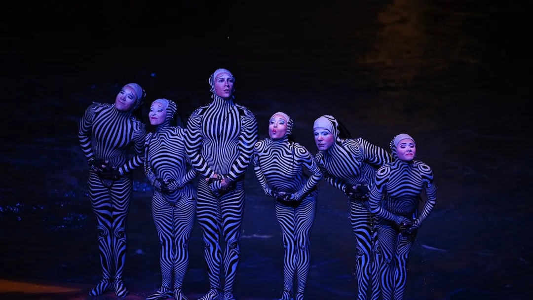 Performers in striped costumes during a theatrical show in Las Vegas.