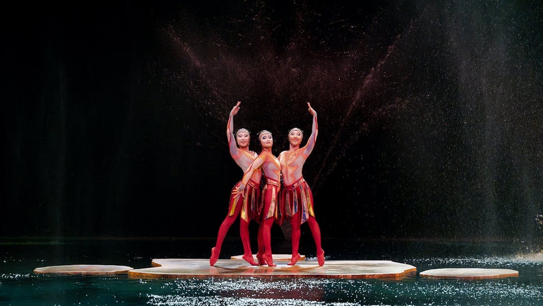 Performers in vibrant costumes on stage at Cirque du Soleil 'O' in Nevada.