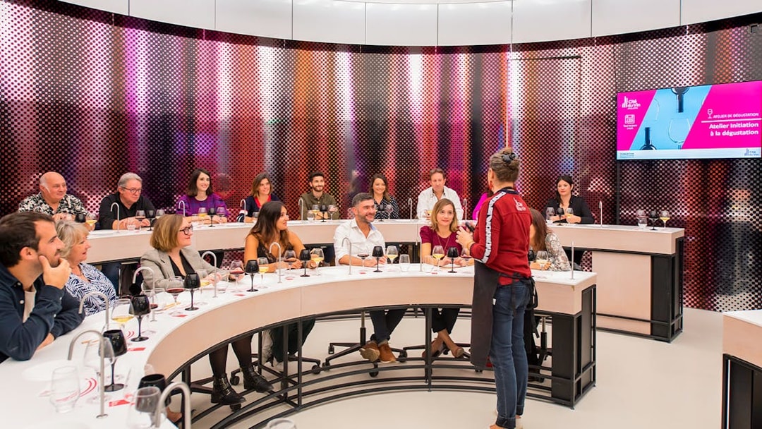 Visitors participating in a wine tasting session at Cité du Vin museum, Bordeaux, France.