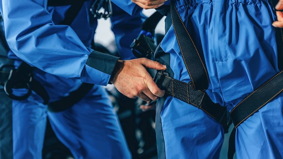 Climbers securing harnesses for City Climb Experience.