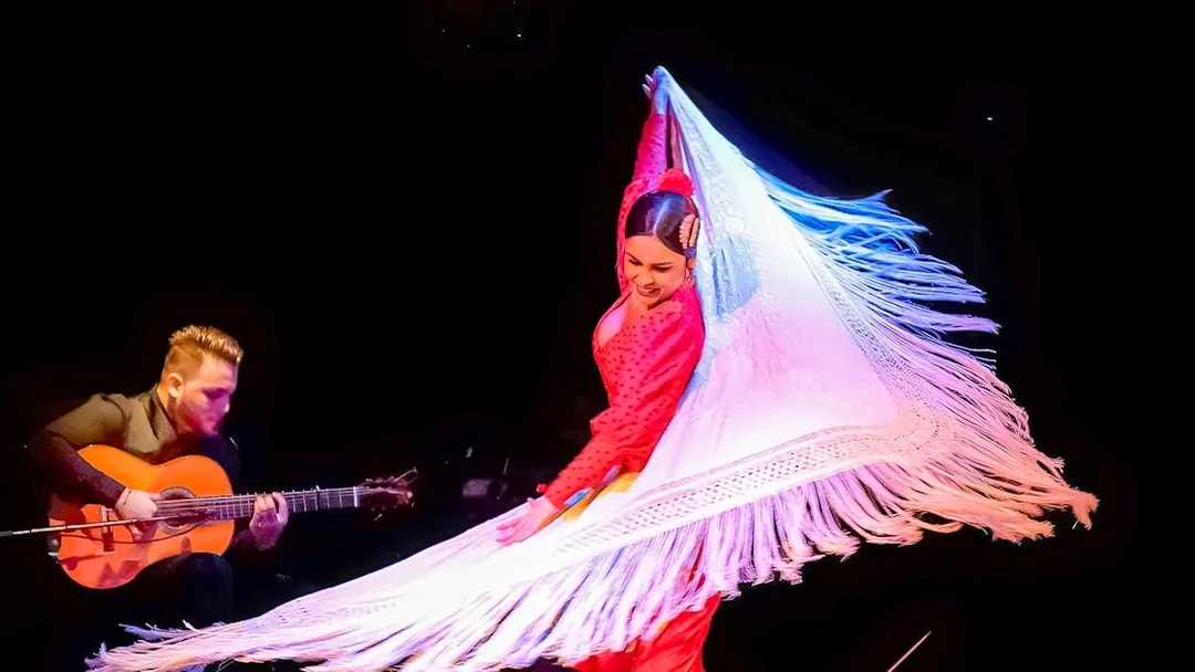 Flamenco dancer performing with guitarist at Flamenco City Hall Theatre.