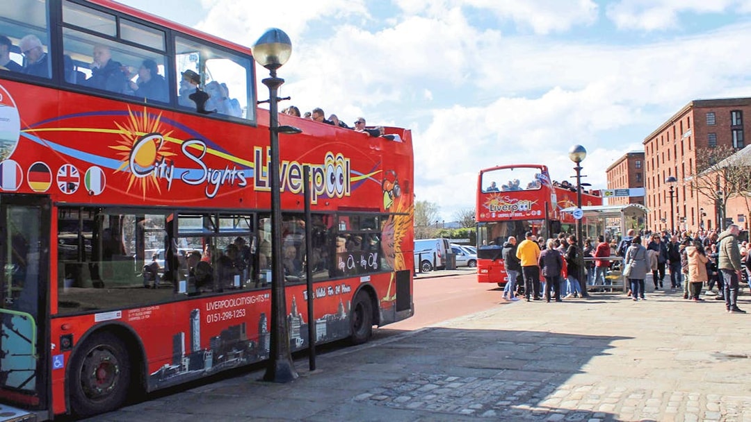Hop On Hop Off bus in Liverpool waiting for passengers at a city tour stop.