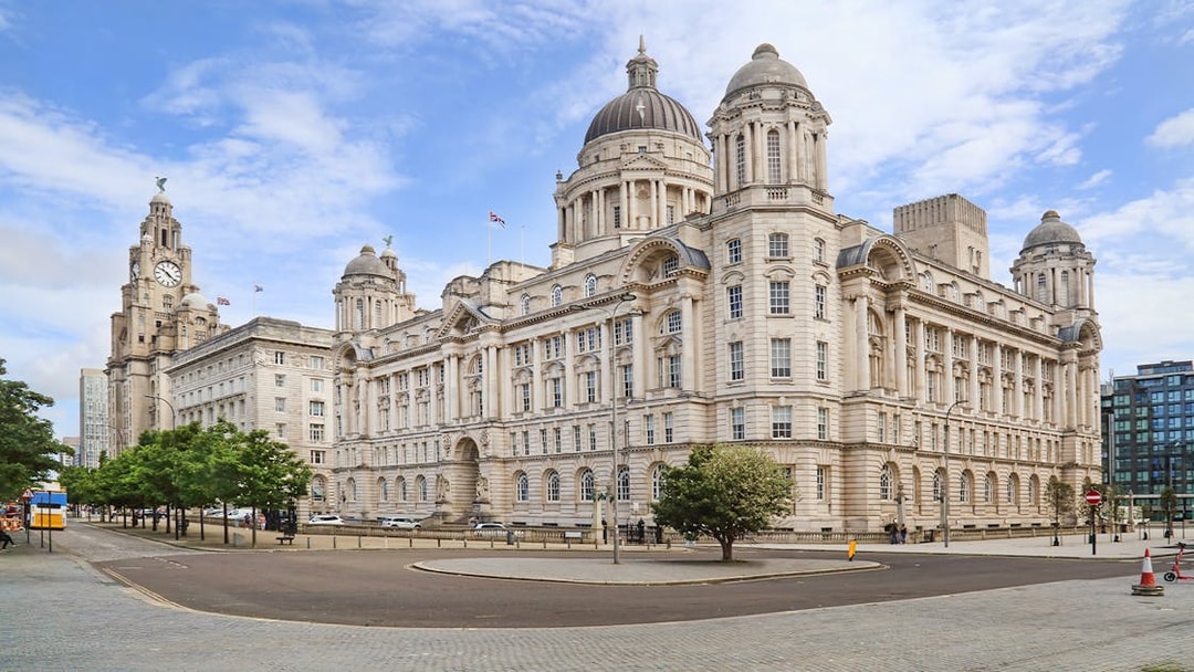 Port of Liverpool Building with hop on hop off bus nearby.