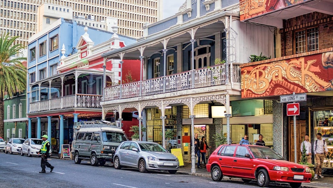 Colorful buildings and parked cars on Long Street, Cape Town, part of a hop on hop off bus tour.