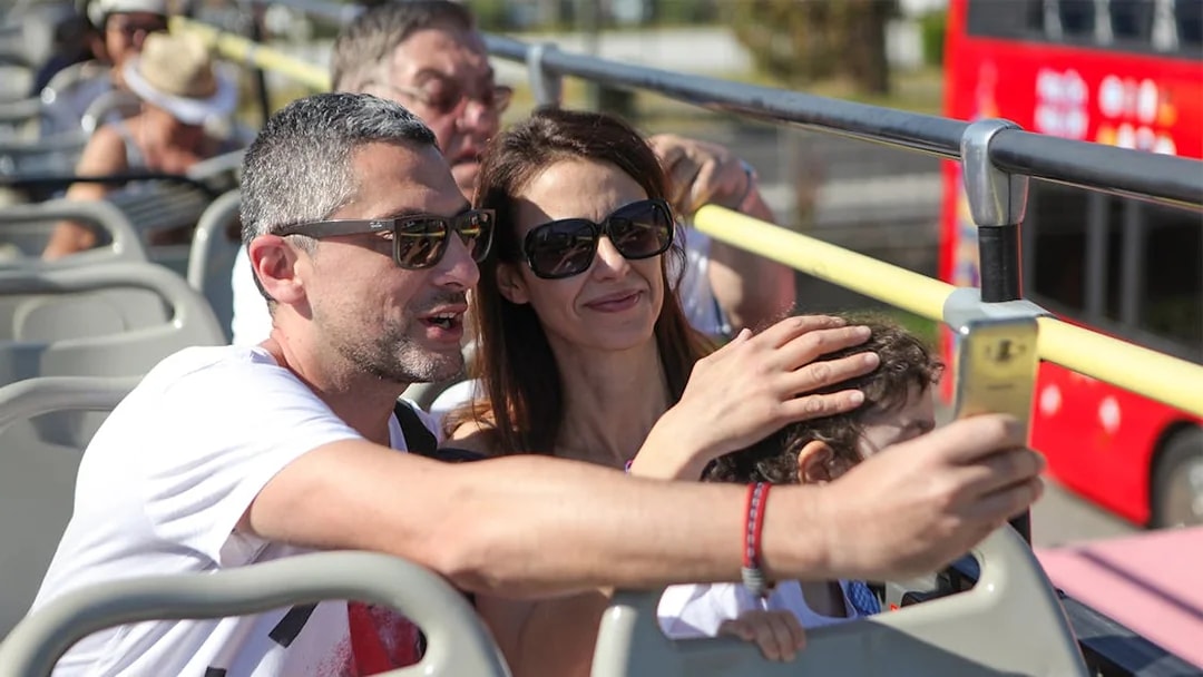 Family taking a selfie on a Corfu sightseeing bus tour.