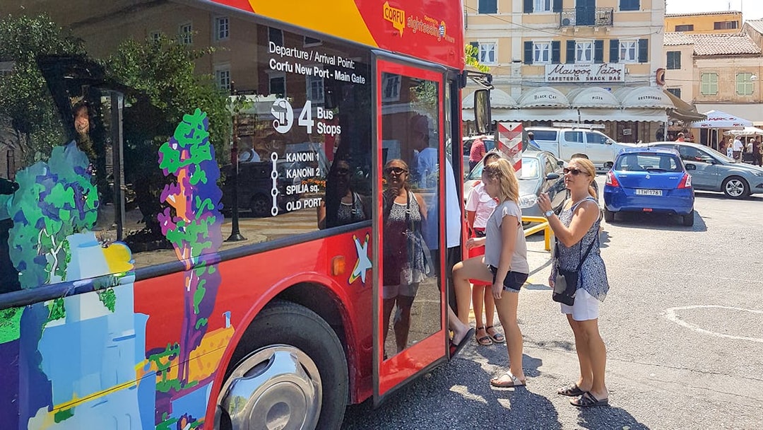 People boarding City Sightseeing hop on hop off tour bus in Corfu.