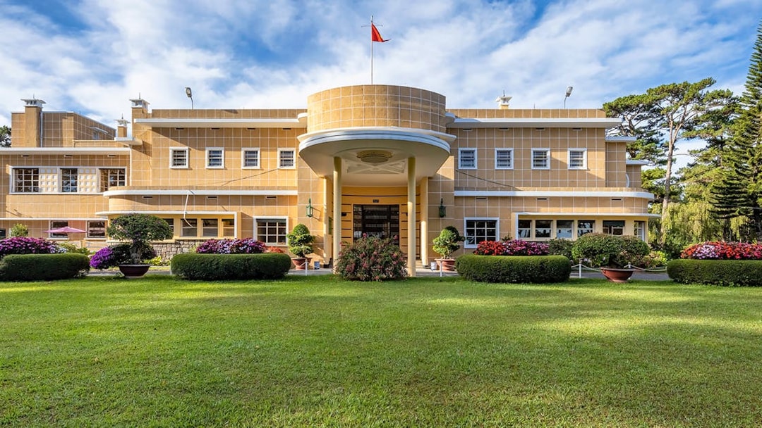 Bao Dai Summer Palace in Da Lat, Vietnam, with manicured gardens and a clear sky.