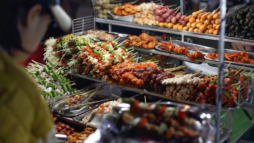 Skewers of grilled meats and vegetables at Da Lat night market food stall.