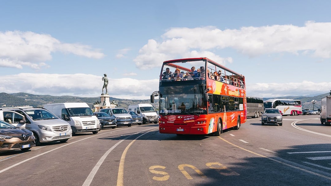 Open-top red bus on Florence Hop-On Hop-Off tour near Piazzale Michelangelo.