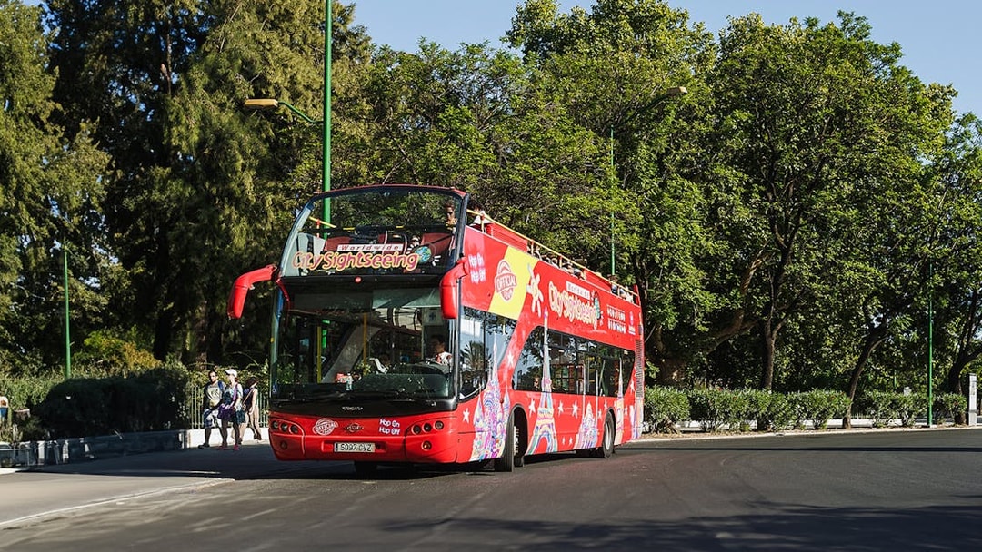 Double-decker sightseeing bus on a Hanoi city tour with tourists onboard.