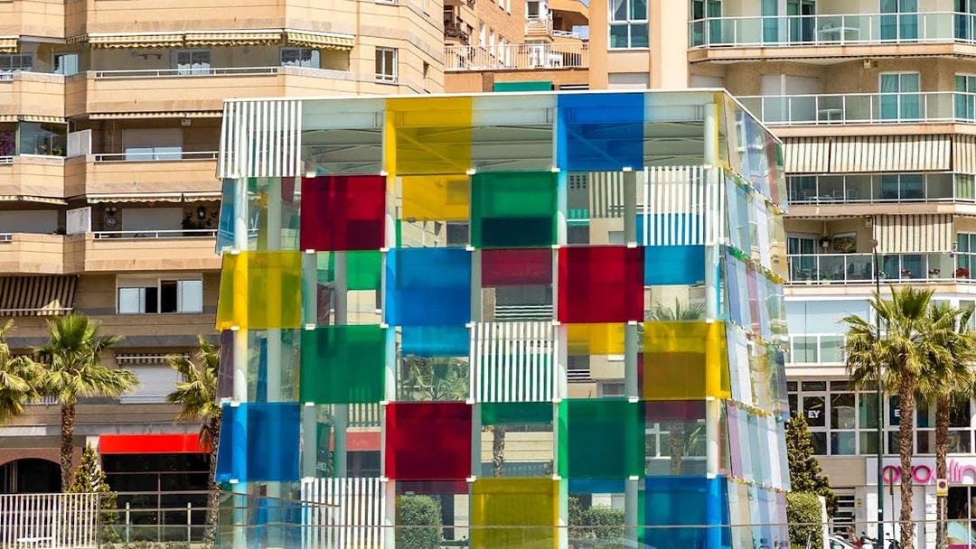 Colorful glass cube structure at Malaga's Pompidou Centre.