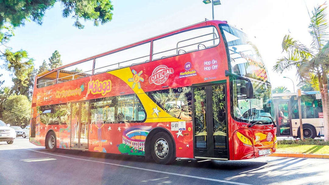 City Sightseeing hop on hop off bus touring Malaga street.