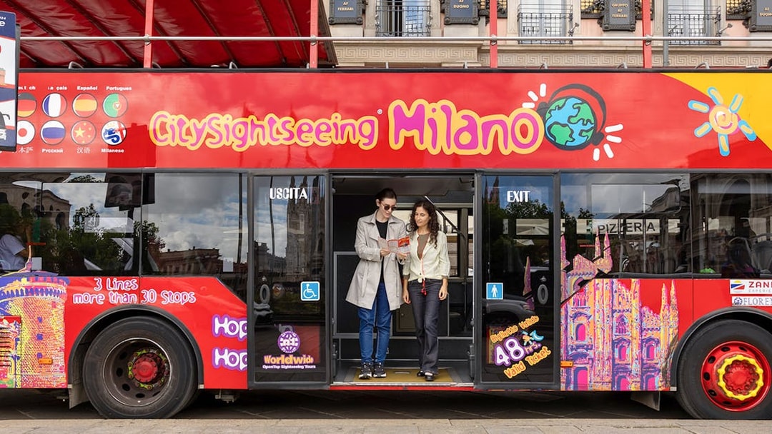 Passengers exiting City Sightseeing hop-on hop-off bus in Milan.