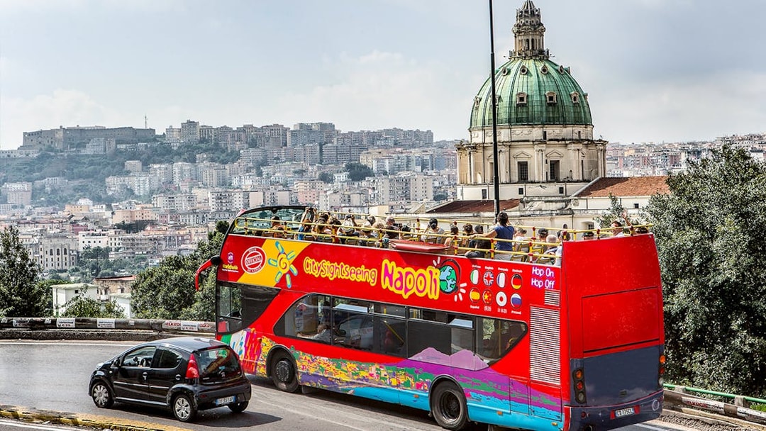 Open-top tour bus near Basilica of the Incarnate Mother of the Good Council, Naples.
