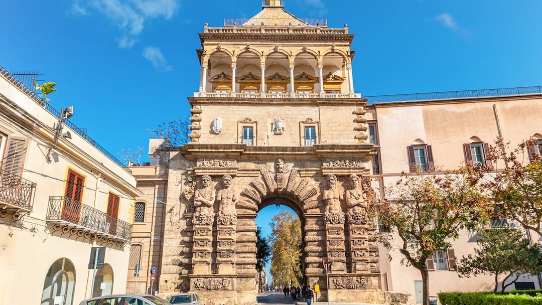 Porta Nuova in Palermo, Italy, showcasing its ornate stone arch and sculptures.