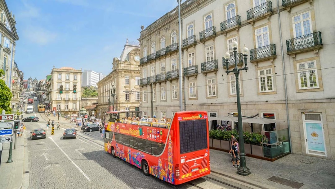 Hop-on hop-off bus touring historic buildings in Porto, Portugal.