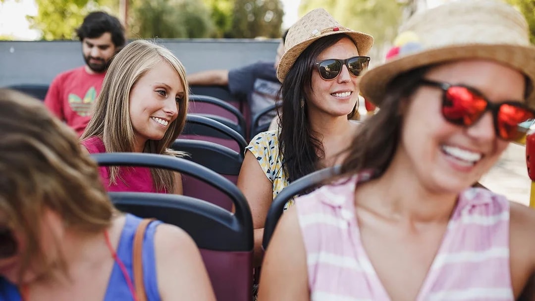 Tourists enjoying Reykjavik hop-on hop-off bus tour.
