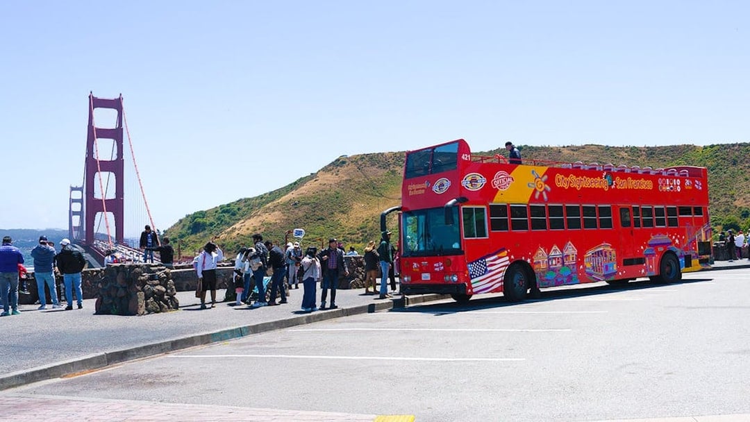 Open-top tour bus near Golden Gate Bridge, San Francisco.