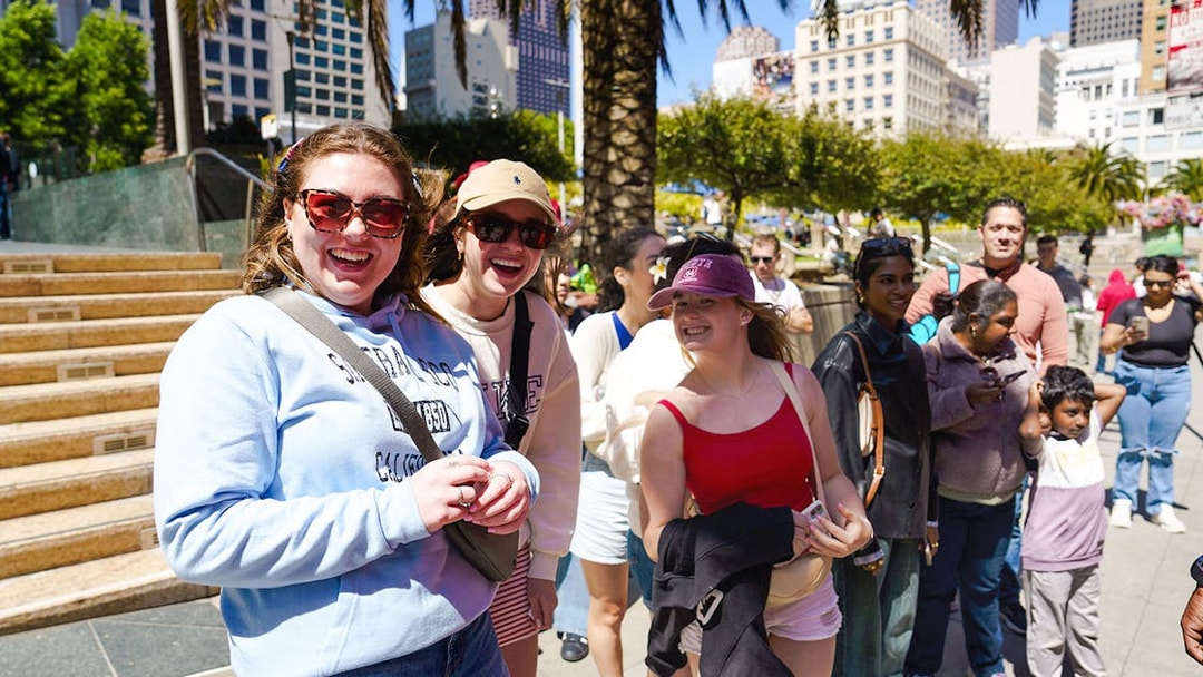 Tourists enjoying a sunny day at Union Square, San Francisco during a hop-on hop-off tour.