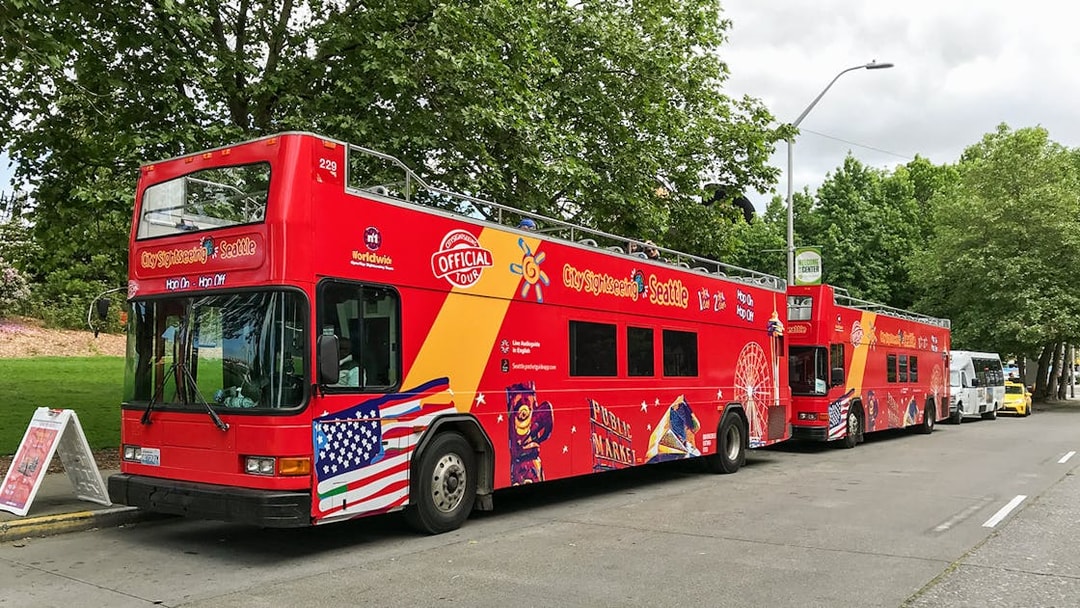 Seattle hop-on hop-off sightseeing bus parked on a tree-lined street.