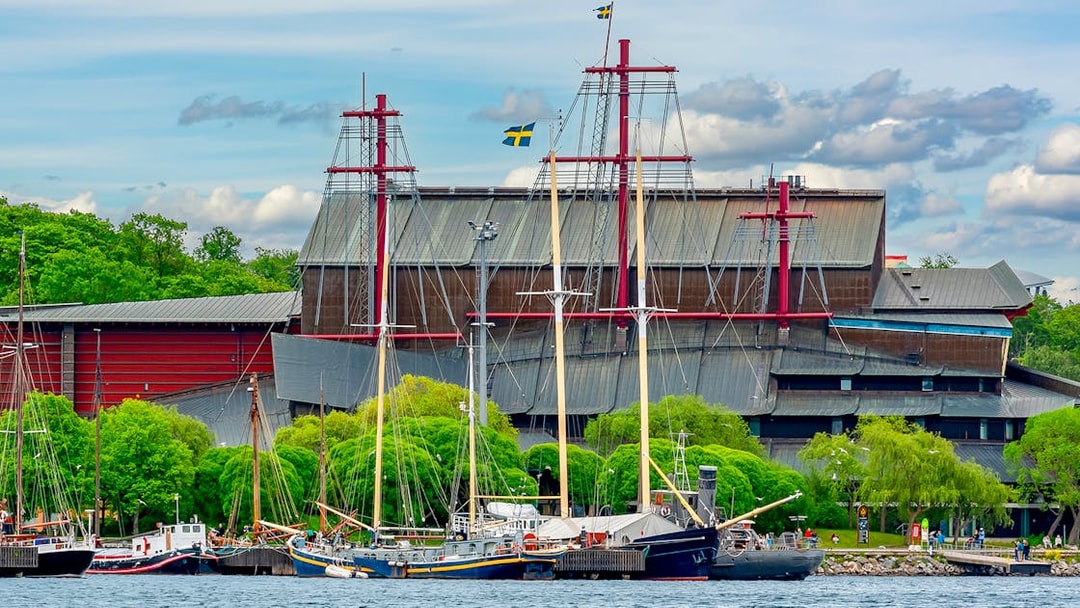 Vasa Museum in Stockholm with ships docked in front.
