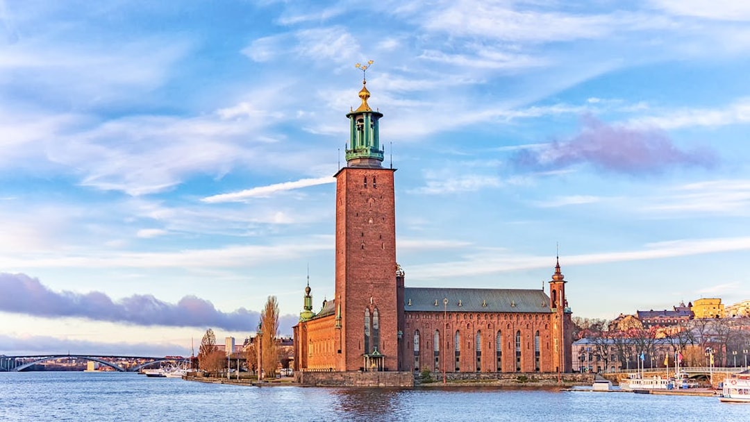 Stockholm City Hall by the water, part of the Hop-On-Hop-Off Tour.