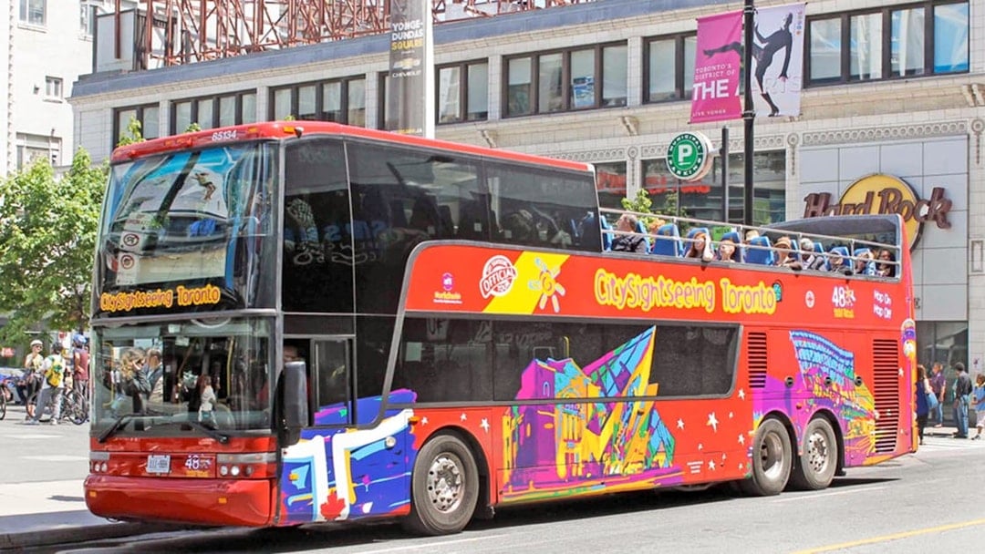 Open top Toronto Hop-On Hop-Off bus near Yonge-Dundas Square.