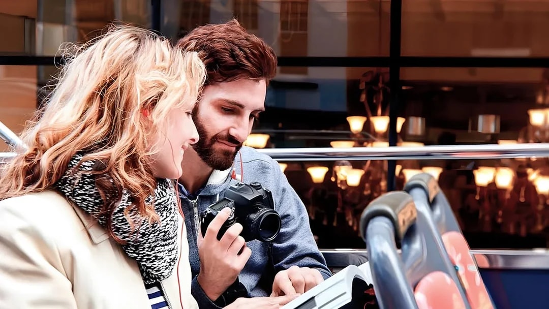 Couple enjoying view on Toronto Hop-On Hop-Off Bus upper deck.