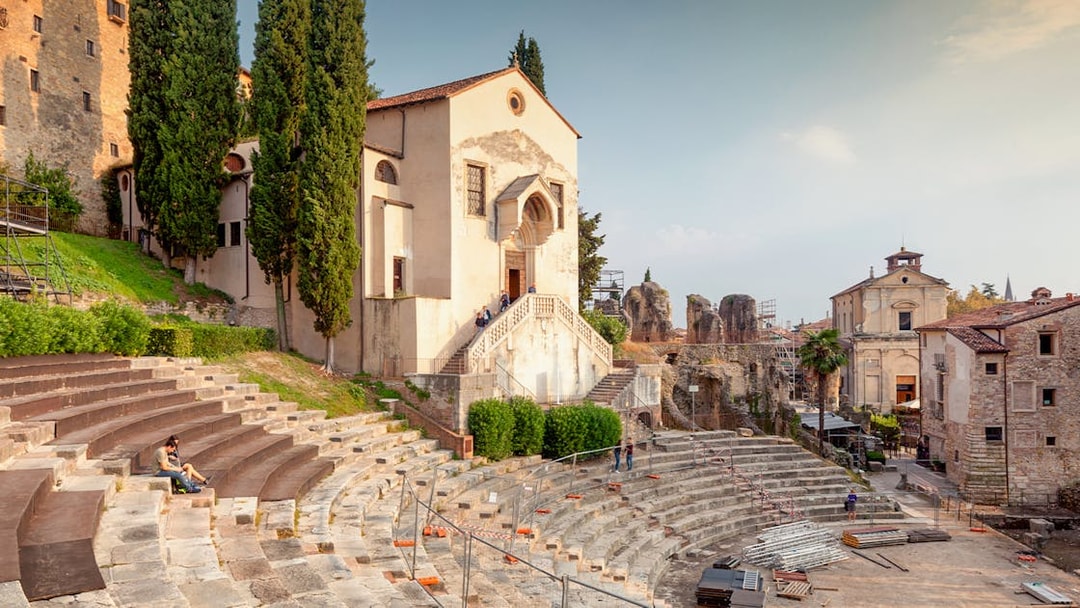 Teatro Romano Verona with ancient stone seating and nearby historic buildings.