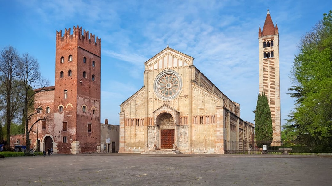 Basilica San Zeno Maggiore in Verona with its distinctive rose window and bell tower.