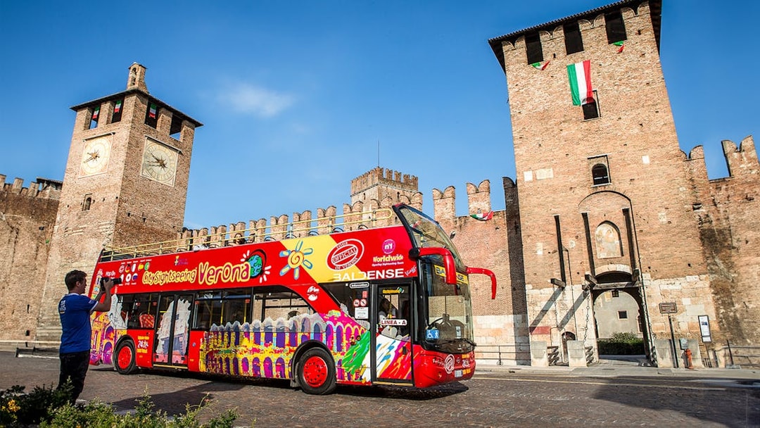 Verona sightseeing bus in front of Castelvecchio, Italy.