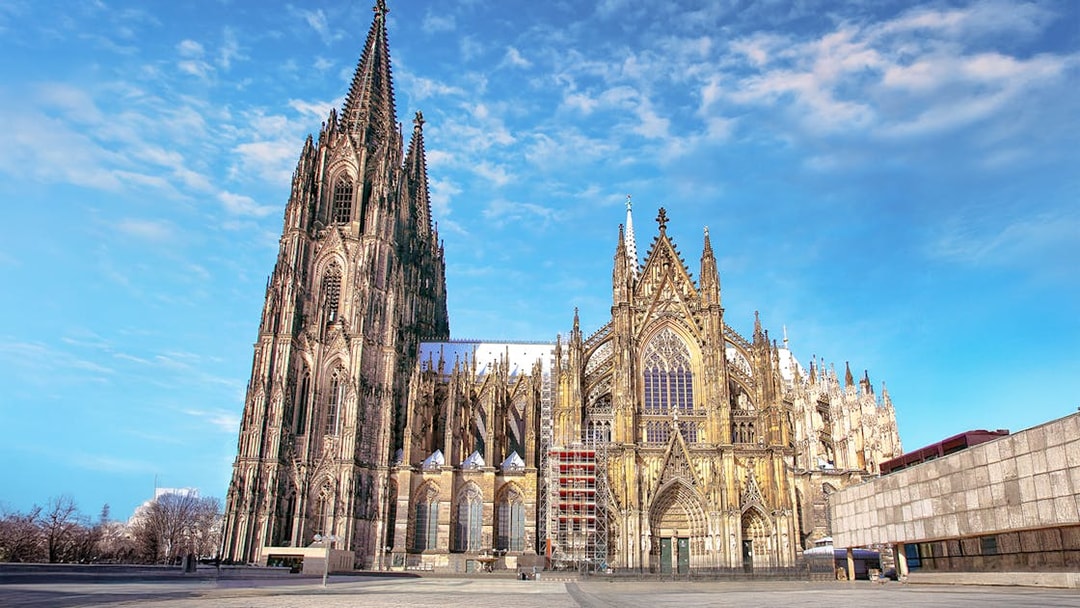 Cologne Cathedral exterior on a sunny day, featured in the City Tour: Cologne Hop-on Hop-off Bus Tour.
