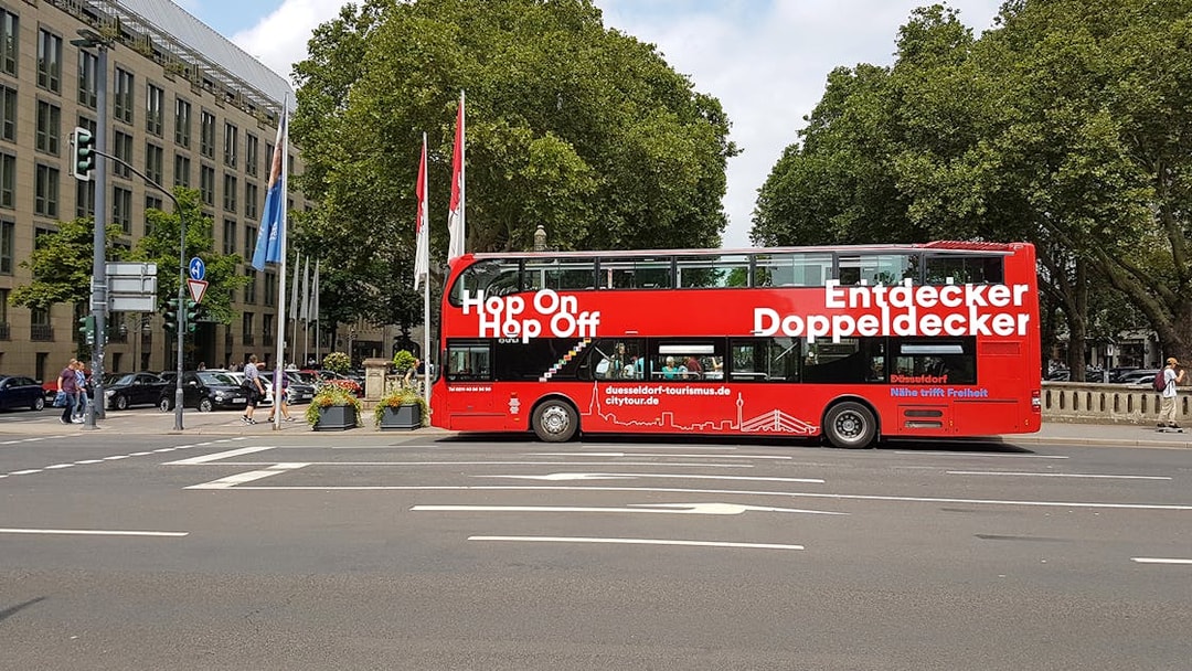 Red double-decker bus for hop on hop off city tour in Düsseldorf.