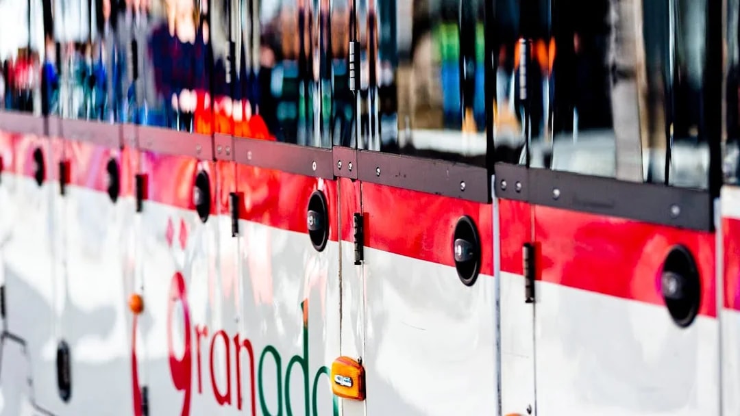Granada tour bus exterior with logo, part of hop-on hop-off service.