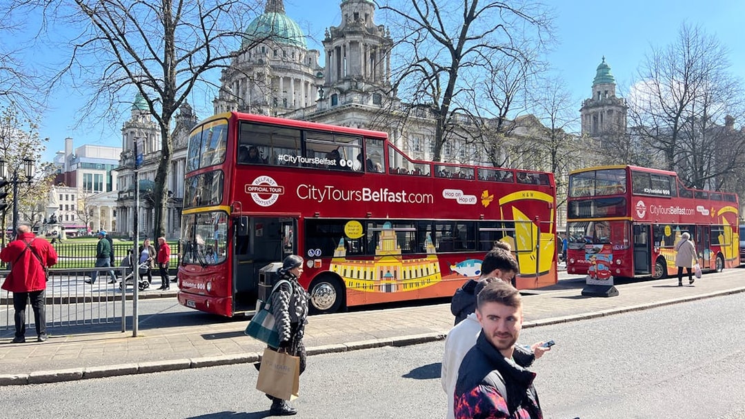 Hop-on hop-off bus in front of Belfast City Hall.