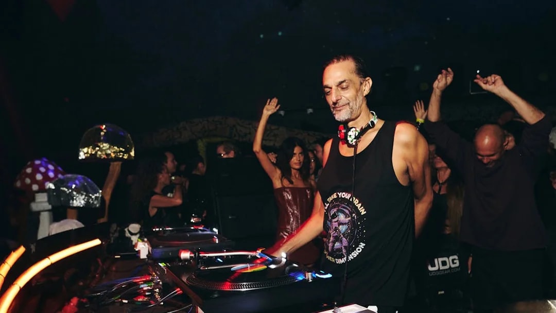 DJ performing at Club Chinois with crowd dancing in Ibiza nightclub.