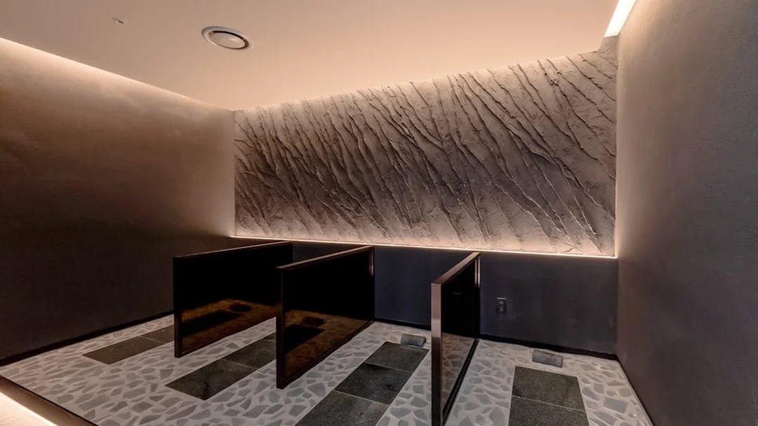 Private shower stalls in the spa at Club D Oasis with textured walls.