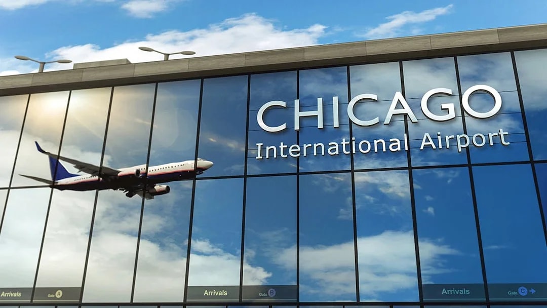 Airplane reflected on Chicago O'Hare Airport glass facade.