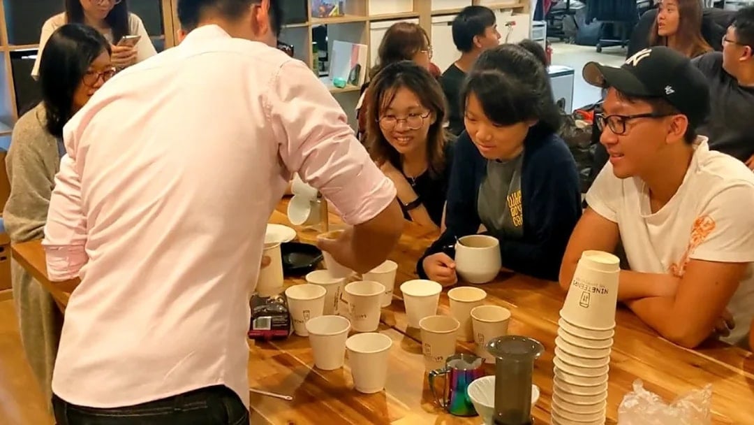 Participants at coffee workshop, Nineteen95 Espresso Bar, learning brewing techniques.