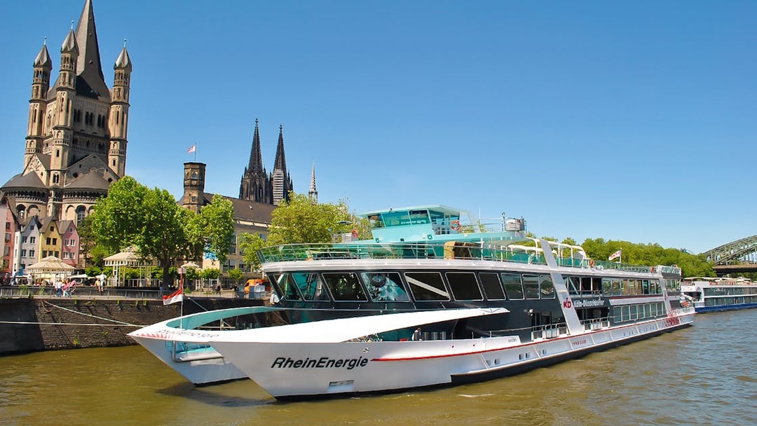 Cruise ship on the Rhine River with Cologne Cathedral in the background.