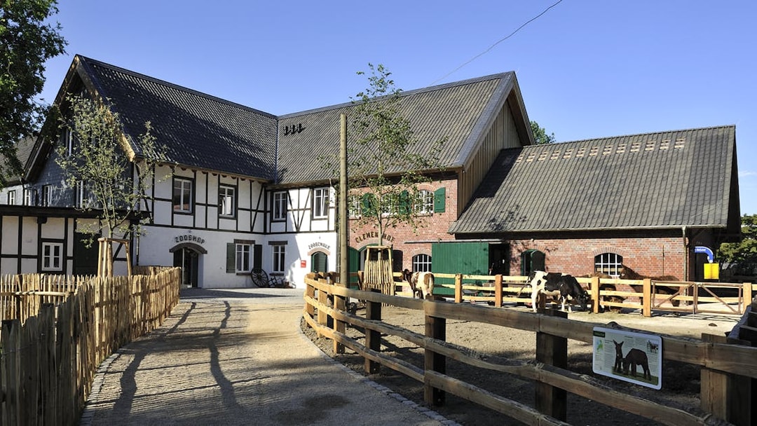 Cologne Zoo Shop exterior with timber-framed building and fenced pathway.