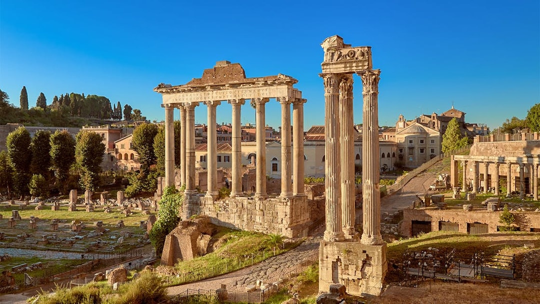Roman Forum ruins with ancient columns in Rome, Italy.